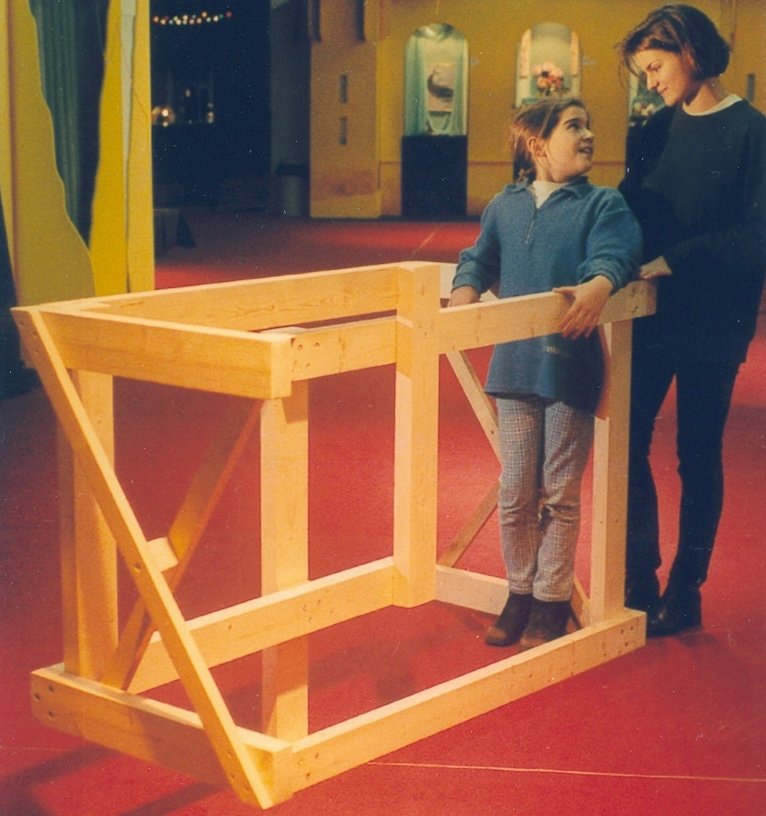 A child at an impossible wooden frame